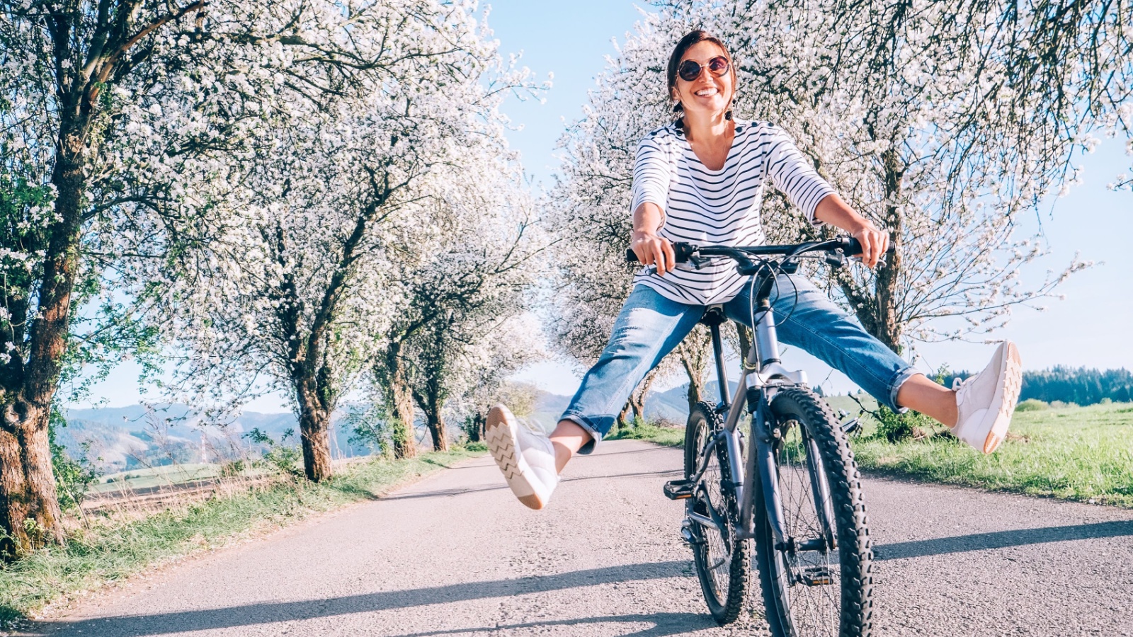 Happy smiling woman on a bike bicycle outdoors fitness Soloviova Liudmyla Shutterstock Happy smiling woman on a bike bicycle outdoors fitness Soloviova Liudmyla Shutterstock