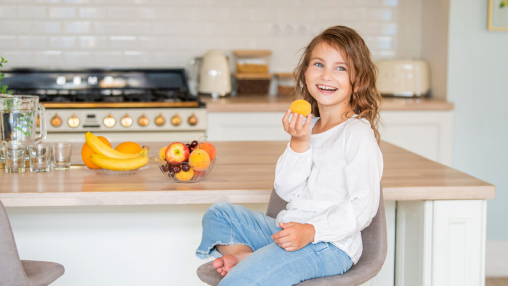 Little Girl Child Healthy Nutrition Eat Apricot Fruit Maria Moroz Shutterstock